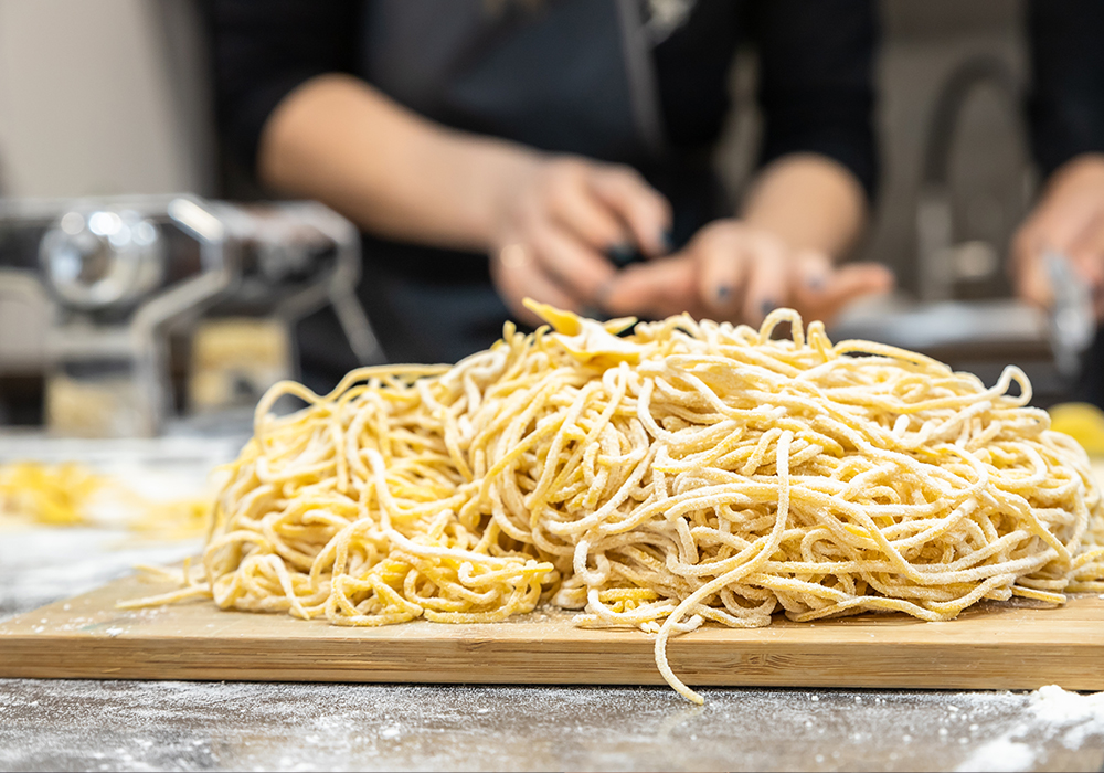 Freshly made artisanal pasta on a wooden cutting board