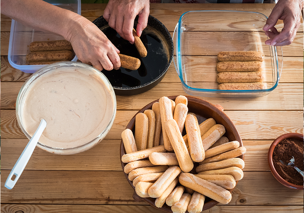 Preparing homemade tiramisu with ladyfinger biscuits